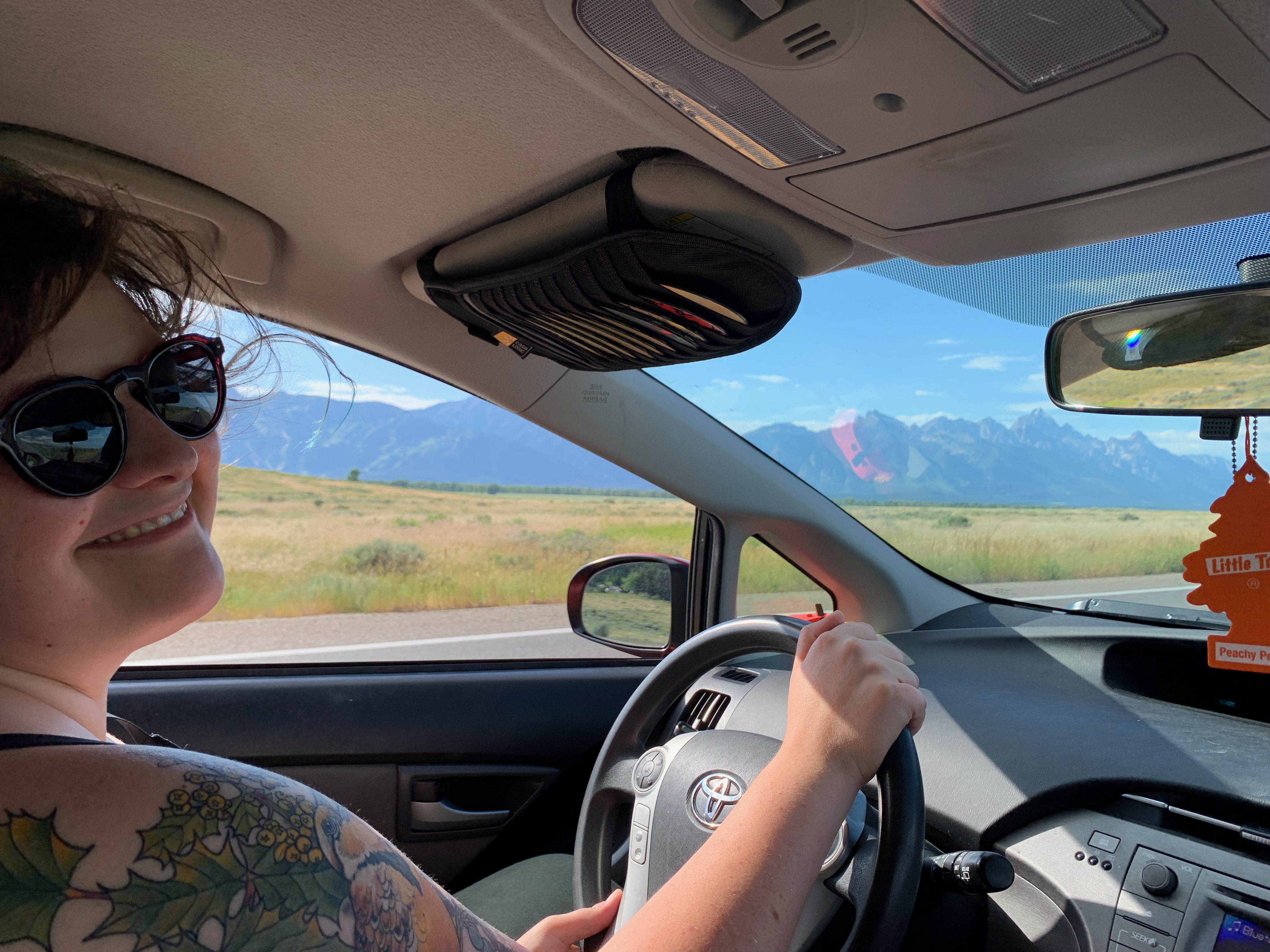 Jaimie driving with the Tetons in the background